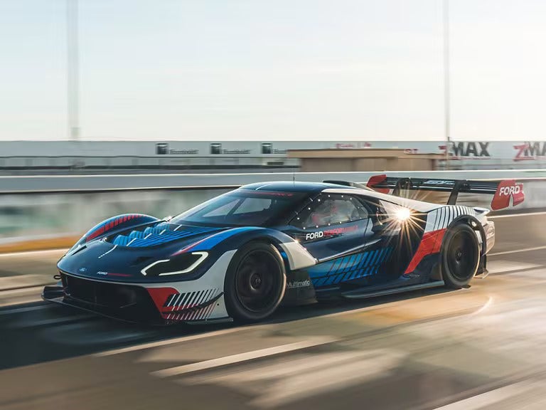 a gt mk iv drivigng on a race track