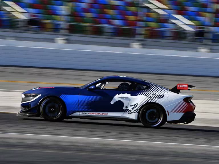 a ford mustang gt4 driving on a racetrack